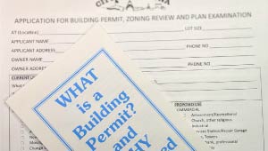 A picture of a building permit and pamphlet.