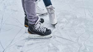 A picture of 2 pairs ice skates on ice.